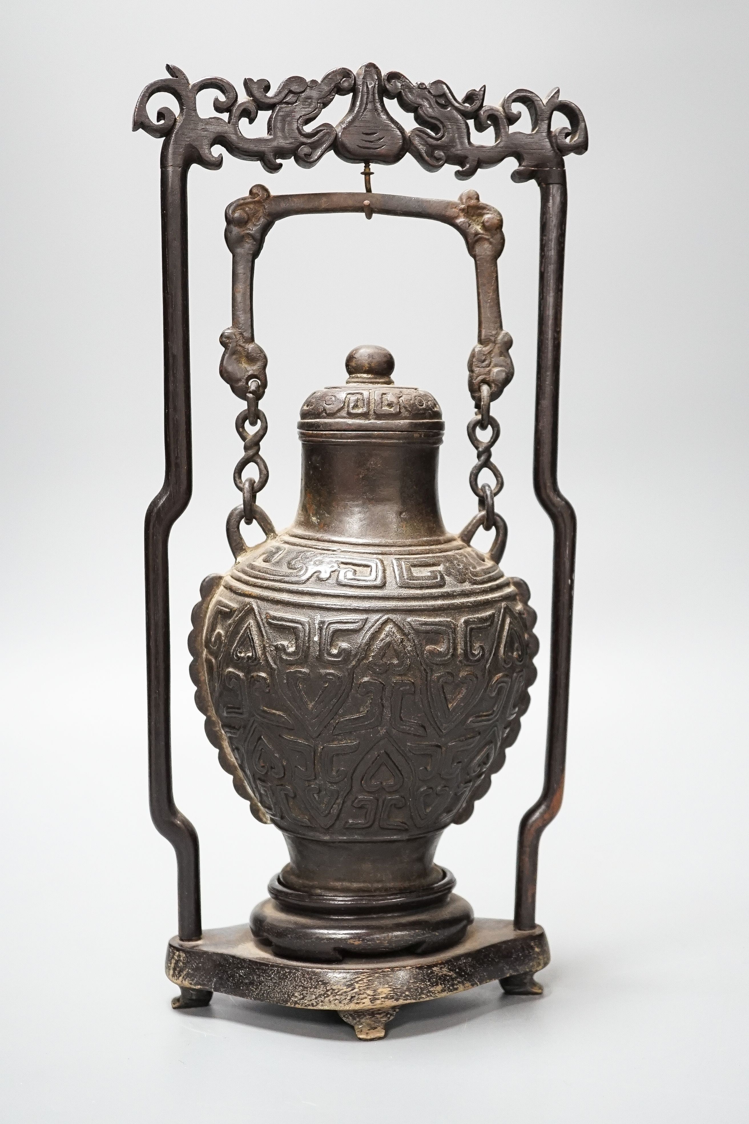 A Chinese archaistic bronze hanging vessel, wood stand 34cm